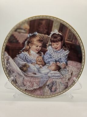 This vintage collector plate is titled "Cats in the Cradle"